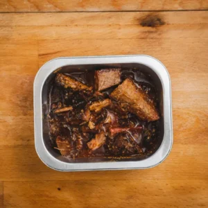 Open can of fish stew displayed.